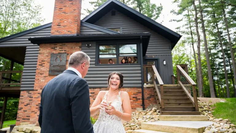 Emotional Bride and Father Moment Outside Rustic Cabin